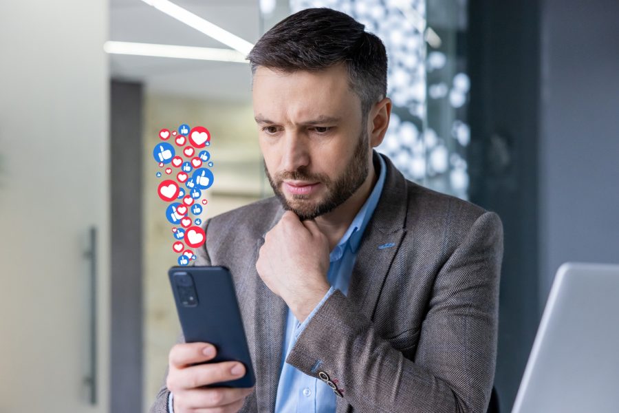 virality in marketing man look at phone with viral post