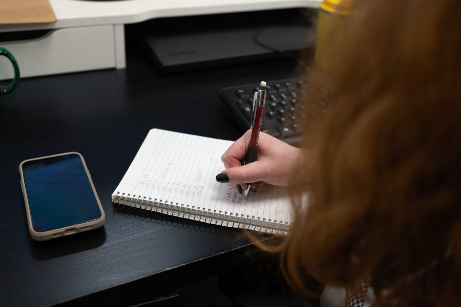 person writing on a notepad at a marketing agency in toronto