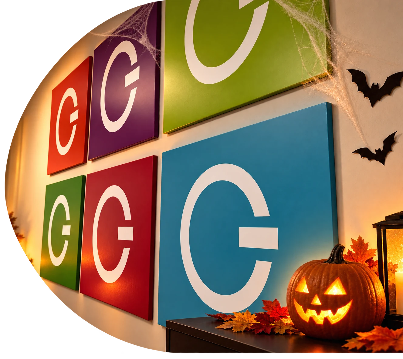 Gilmedia logo wall decorated for Halloween with a glowing pumpkin and autumn leaves